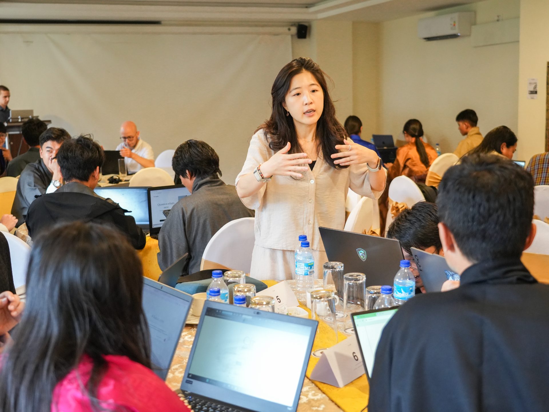 Participants talking between sessions at AI Studio